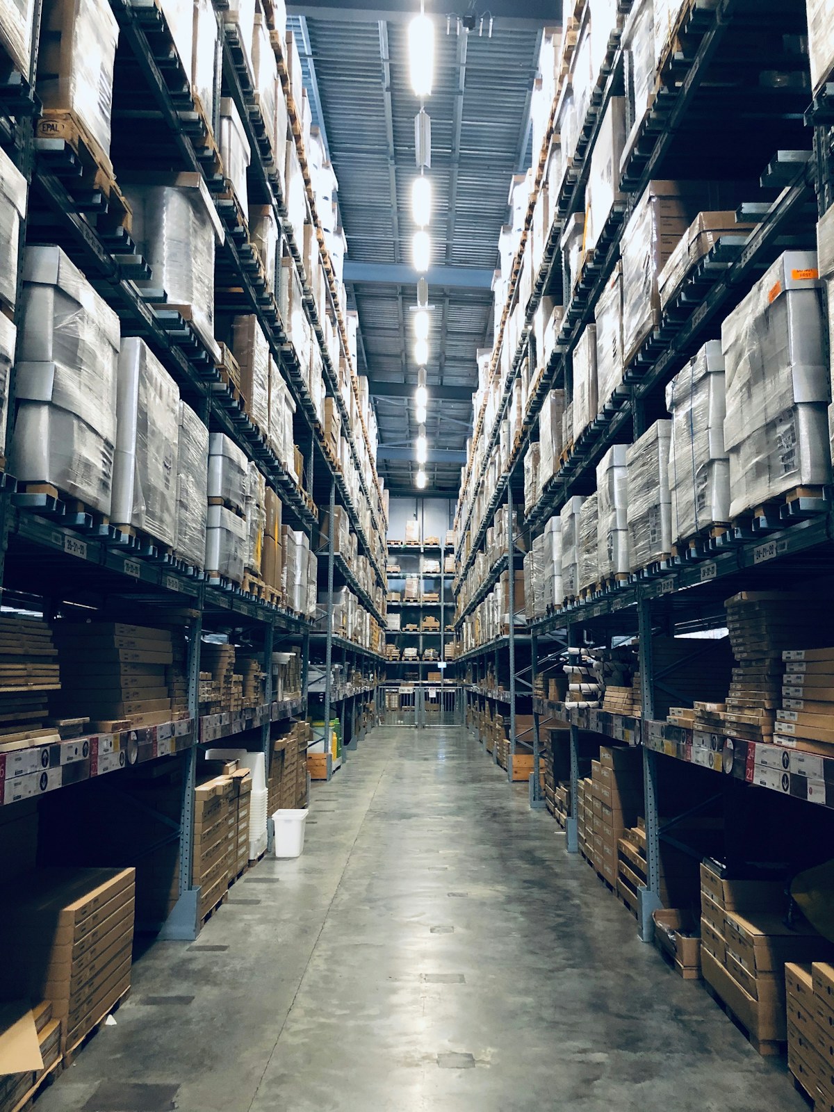 Warehouse aisle lined with organised racks of packaged goods